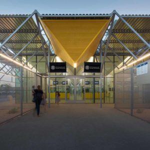 person walking towards glass doors of san luis north annex building at land port of entry