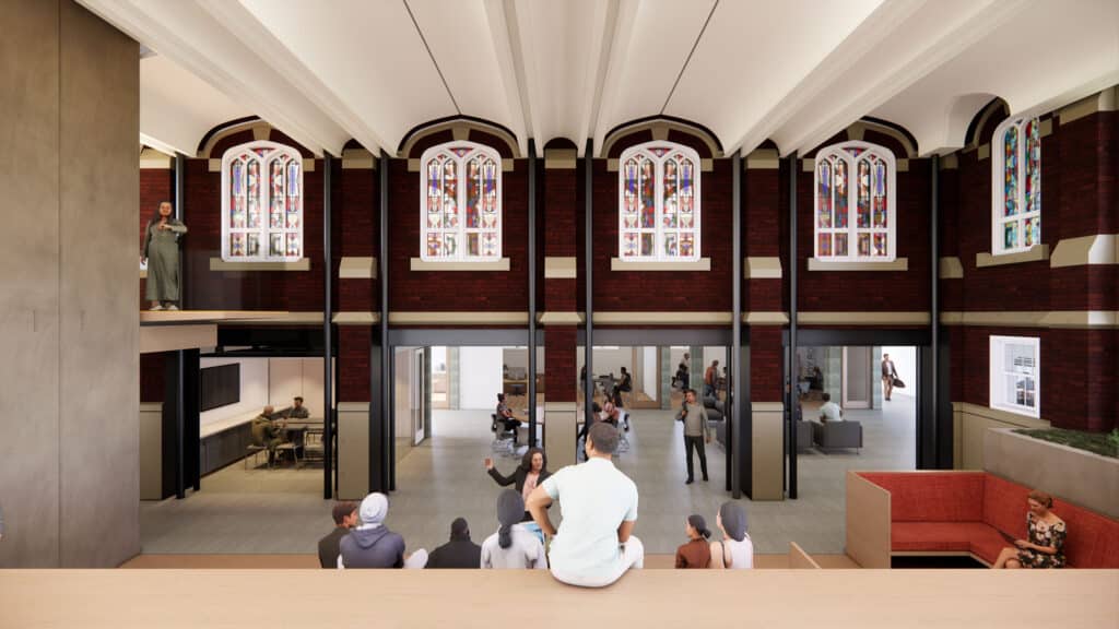 connection of previously exterior brick wall including stained glass windows on upper level, lower level with round tables and office space