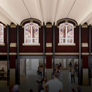 connection of previously exterior brick wall including stained glass windows on upper level, lower level with round tables and office space